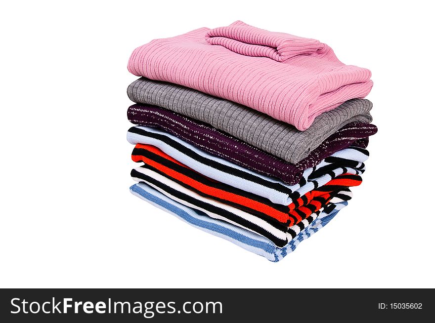 Stack Of Colorful Winter Sweaters  On A White.
