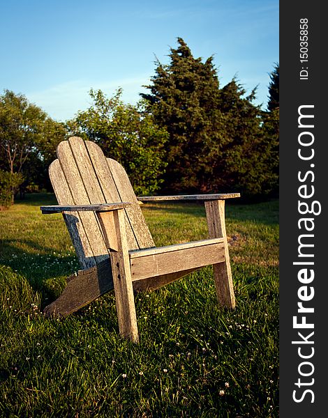 Empty chair in a meadow facing the sunset. Empty chair in a meadow facing the sunset
