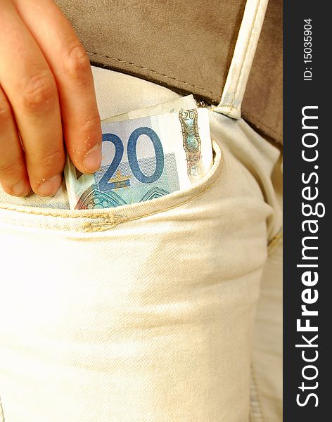 Person extracts twenty euros in jeans pocket