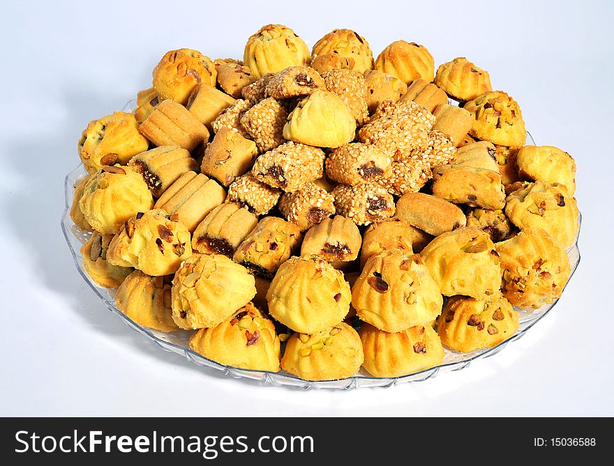 Dates filled Cookies with Pista,Seasame, in a plate & white background