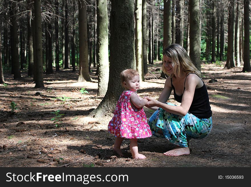 The mum with the daughter near a tree. The mum with the daughter near a tree