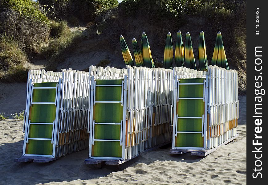 Lines of deck chairs on a beach