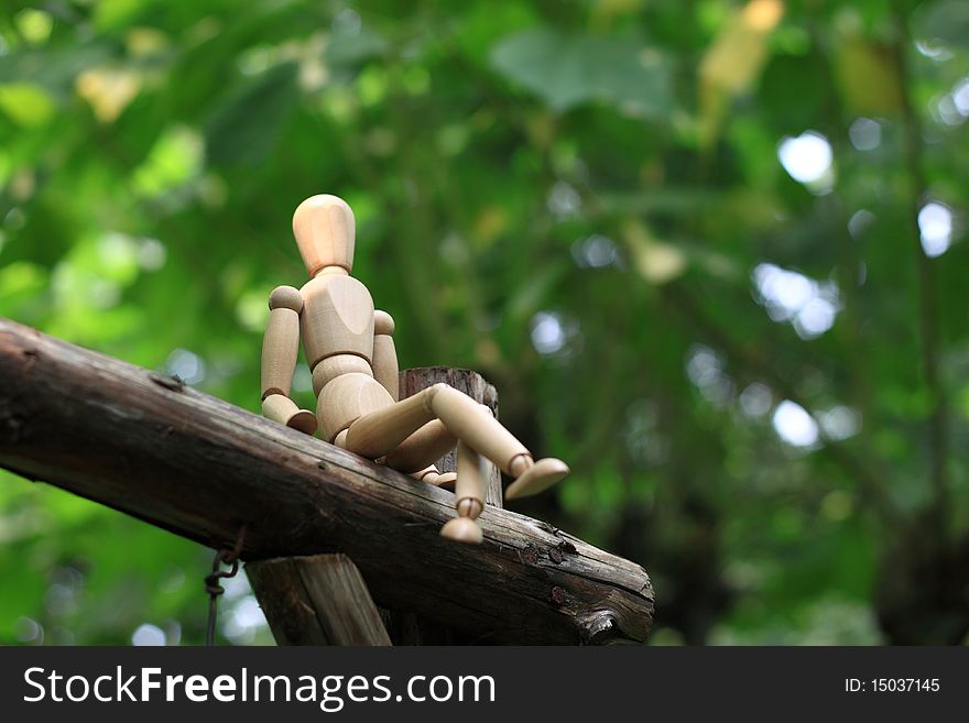 Puppet sitting in the woods, peaceful time in the sunshine.