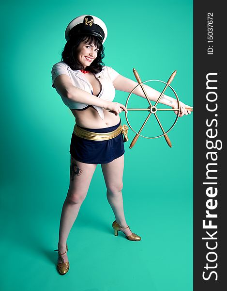Nautical pinup girl with boat steering wheel