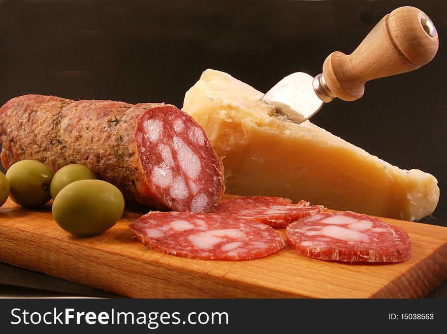 Salami with green olives and parmesan cheese for a tasty snack