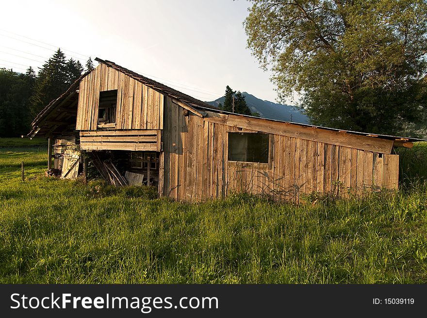 An old wooden barn during sunset