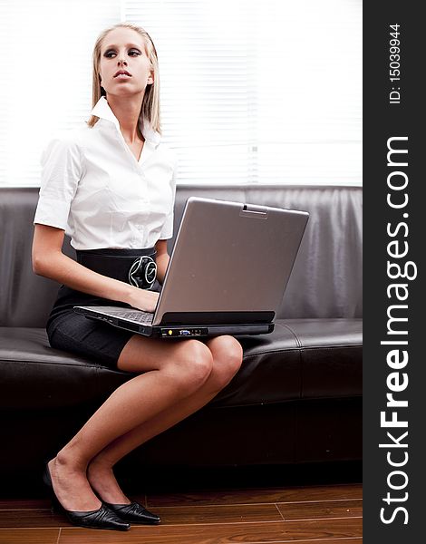 Attractive fashion businesswomen typing on the lap top at home. Attractive fashion businesswomen typing on the lap top at home