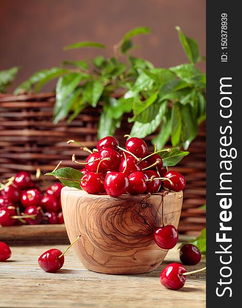 Red Sweet Cherry In A Wooden Bowl On A Wooden Table In Garden