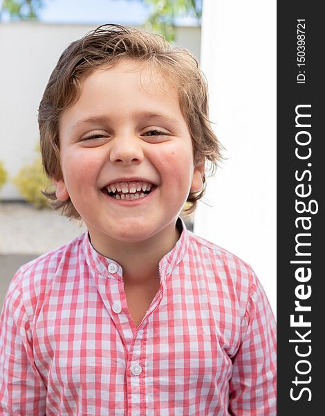 Happy child with pink shirt in the garden