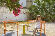 A Little Girl On Carousel In Playground Royalty Free Stock Photo A Little Girl On Carousel In Playground Royalty Free Stock Photo