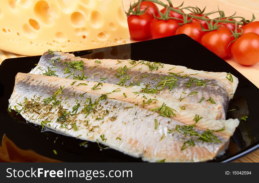 Herring on black plate