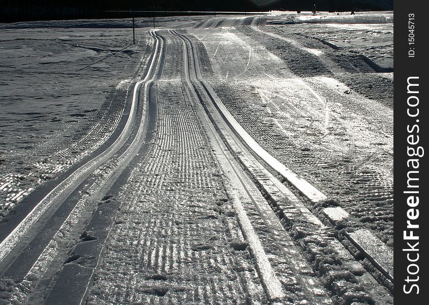 Tracks of a vehicle through the snow. Tracks of a vehicle through the snow