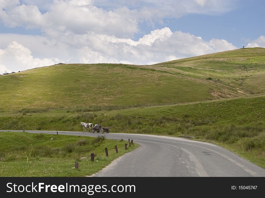 Mountain asphalt road with horse cart in Transylvania around Sibiu, Romania