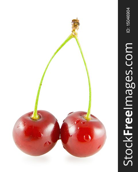 Two cherries with water drops on white background