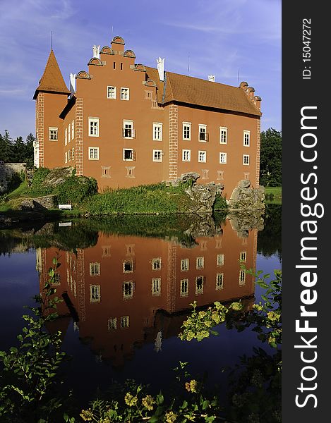 The red chateau of Cervena Lhota in Czech Republic with water reflection. The red chateau of Cervena Lhota in Czech Republic with water reflection