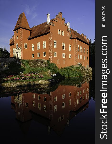 The red chateau of Cervena Lhota in Czech Republic with water reflection. The red chateau of Cervena Lhota in Czech Republic with water reflection