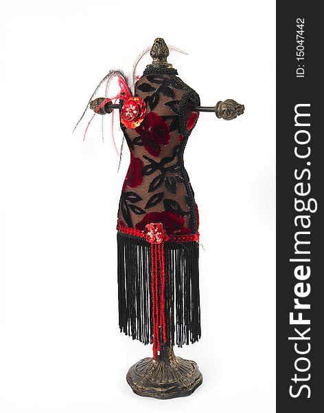 Black and red jewelry holder with feathers on a white background