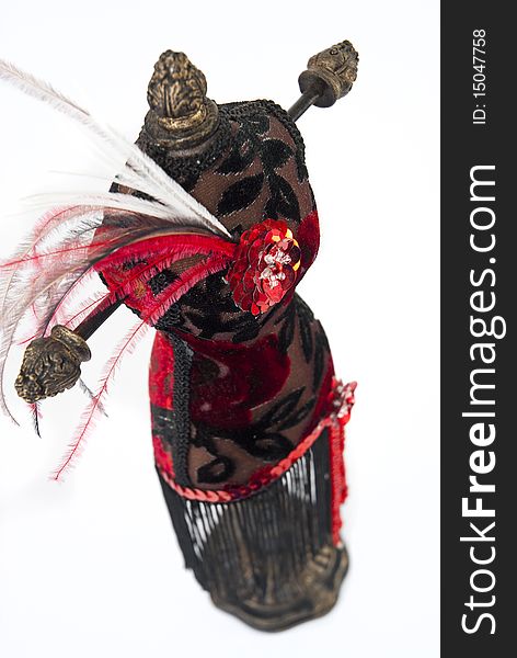 Black and red jewelry holder with feathers on a white background