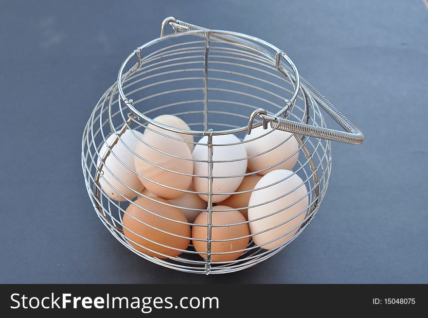 This is a chrome basket with eggs in it. This is a chrome basket with eggs in it.