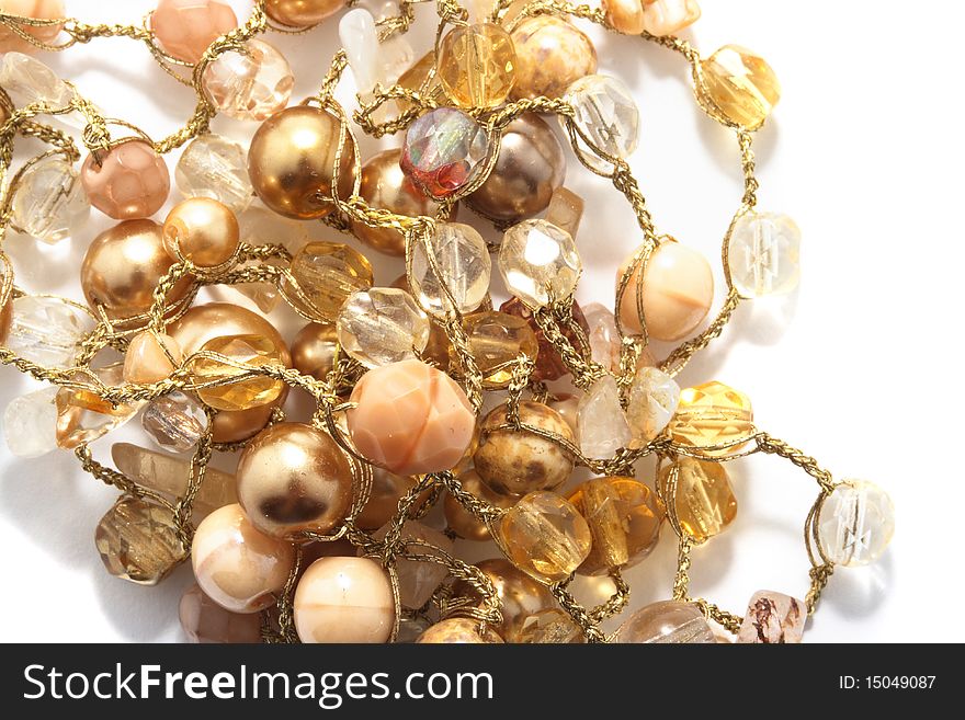 Golden and yellow beads over white