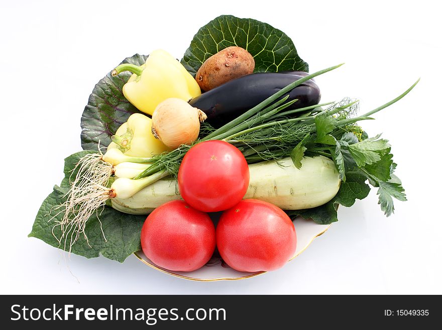 Still life fresh vegetables on plate on white background