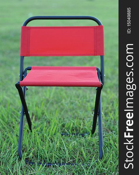 Folds chair in the lawn background. Folds chair in the lawn background