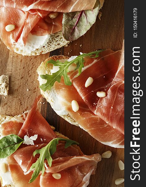 Traditional Parma Cured Ham Antipasto. Bruschetta Set With Parma Ham And Parmesan Cheese. Small Sandwiches With Prosciutto,
