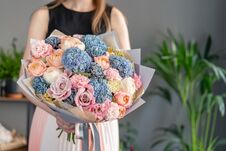 Beautiful Bouquet Of Mixed Flowers In Woman Hand. Floral Shop Concept . Handsome Fresh Bouquet. Flowers Delivery. Blue Stock Photography