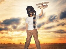 Child Pilot Aviator With Airplane Dreams Of Traveling In Summer In Nature At Sunset Royalty Free Stock Photography