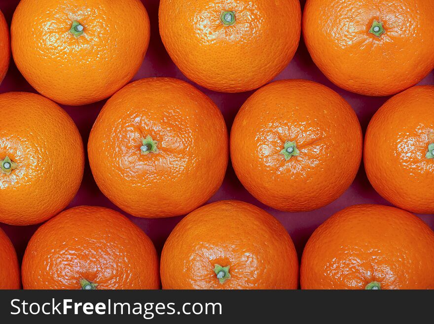 Many organic oranges placed in rows