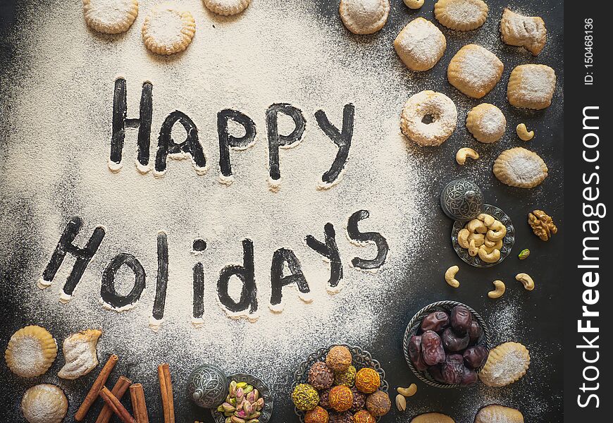 Happy Holidays Food Background. Arab Sweets Are Laid Out On A Black Table.