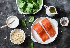 Ingredients For A Balanced Lunch - Salmon Fish, Spinach, Cream, Orzo Pasta On A Dark Background, Top View Royalty Free Stock Photography