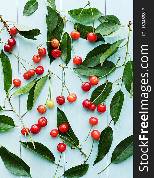 Cherries with leaves on wooden background. Shallow dof. Cherries with leaves on wooden background. Shallow dof