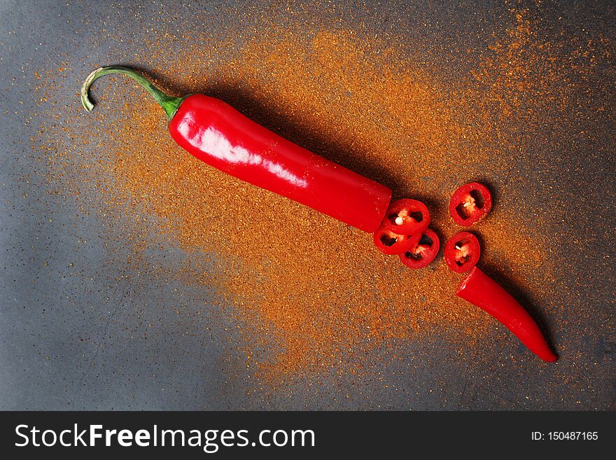 Red Chili Pepper At Dark Background With Paprika Powder