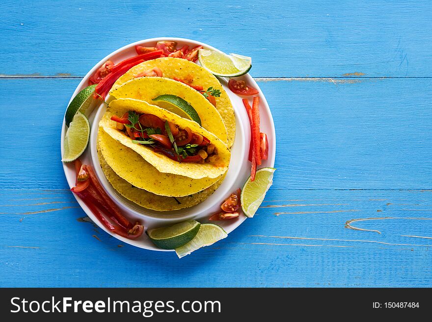 Healthy Mexican Tacos with Ground Beef and Vegetables on Rustic Blue Background