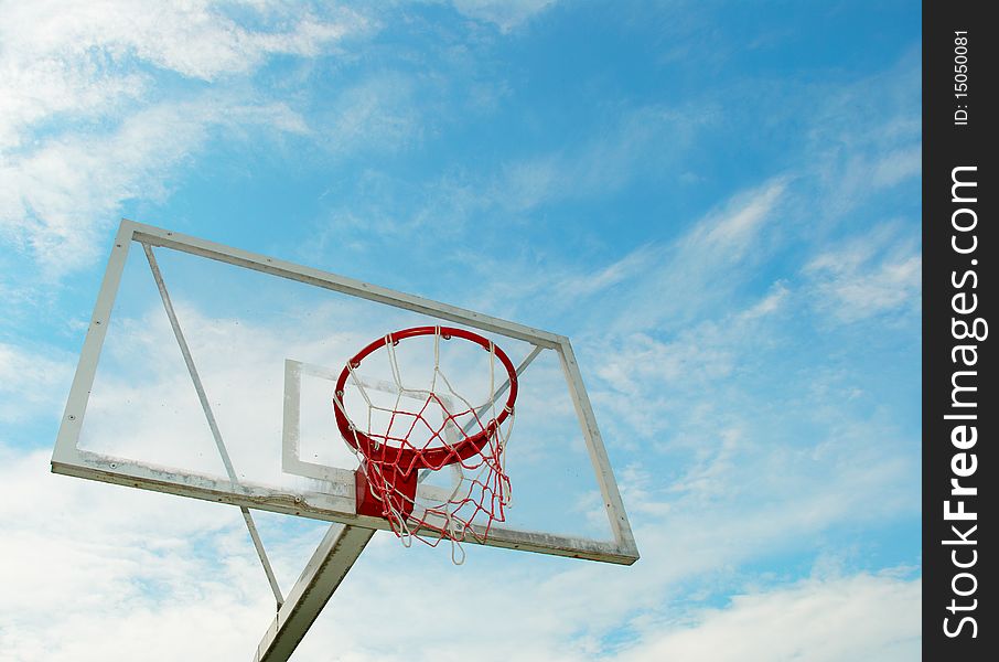 Outdoor basketball hoop on a blue sky background. Outdoor basketball hoop on a blue sky background