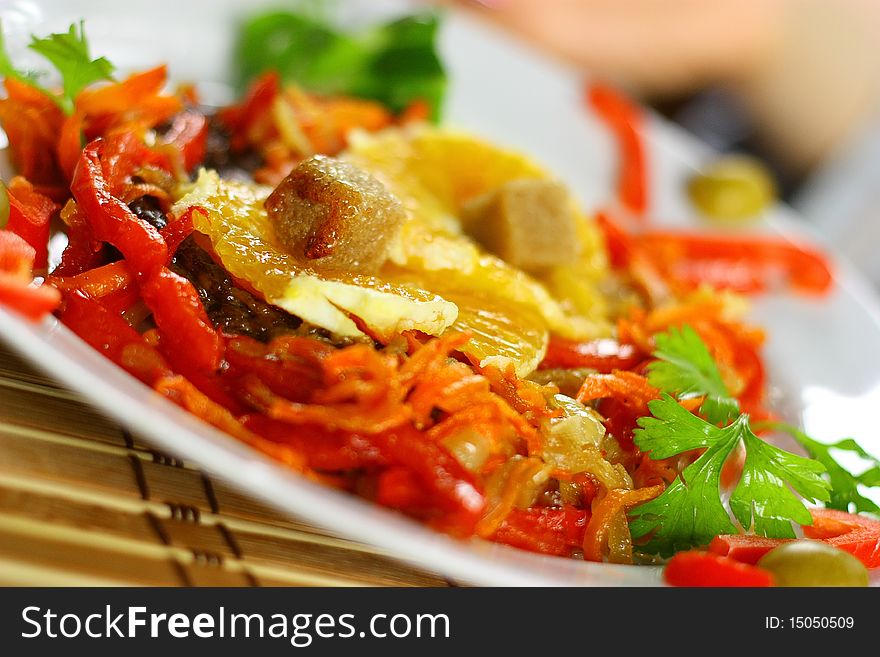 Delicious meat with sweet pepper, greenery, pine-apple and carrots on the plate. Delicious meat with sweet pepper, greenery, pine-apple and carrots on the plate.