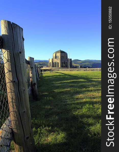 Historical vista house and the fence post surrounding a small grassy area. Historical vista house and the fence post surrounding a small grassy area.