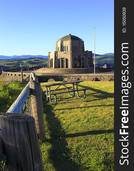 Historical vista house and the fence post surrounding a small grassy area and picnic table. Historical vista house and the fence post surrounding a small grassy area and picnic table.