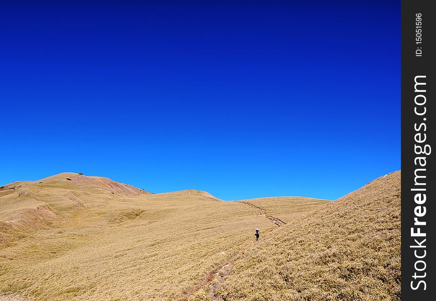 Blue sky on the highland with a hiker. Blue sky on the highland with a hiker