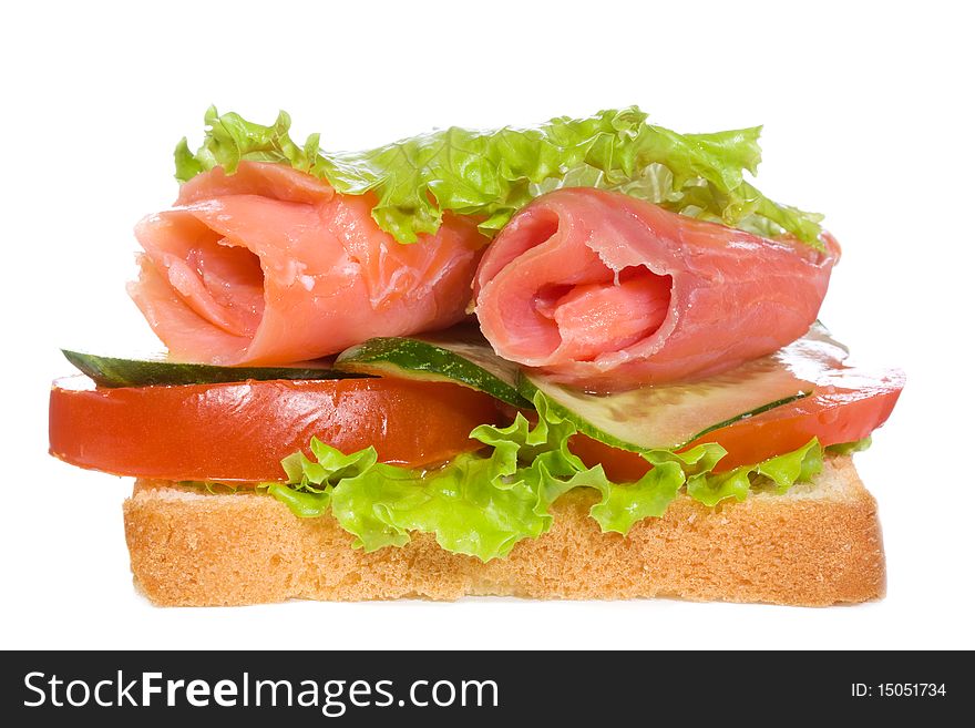 Sandwich with smoked salmon and vegetables on white background