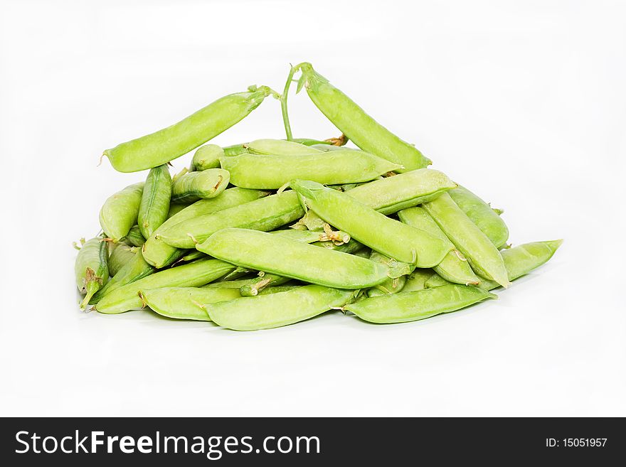 Pods of green pea are isolated on white