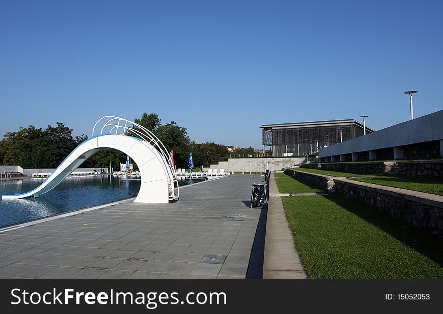 Dispeopled bath pool with white slide