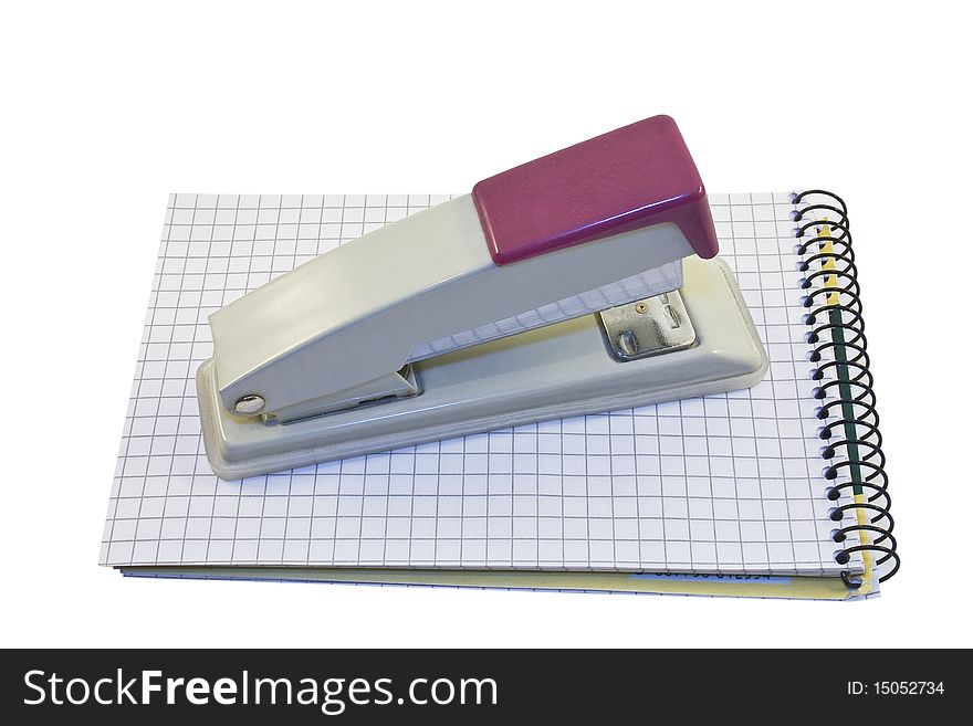 Stapler and notebook isolated on the white