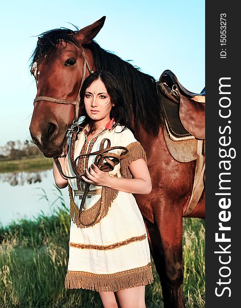 Beautiful young woman posing with a brown horse. Beautiful young woman posing with a brown horse.