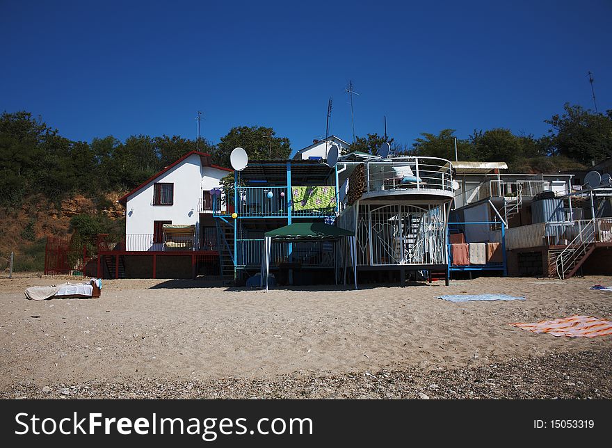 Summer small houses on sandy sea coast