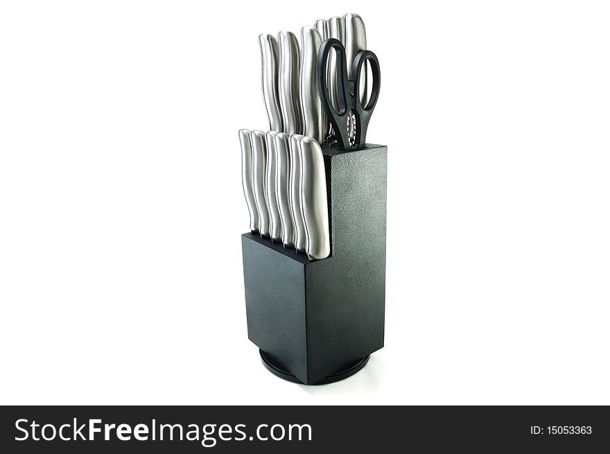 A set of kitchen knives at a stand isolated on a white background. A set of kitchen knives at a stand isolated on a white background