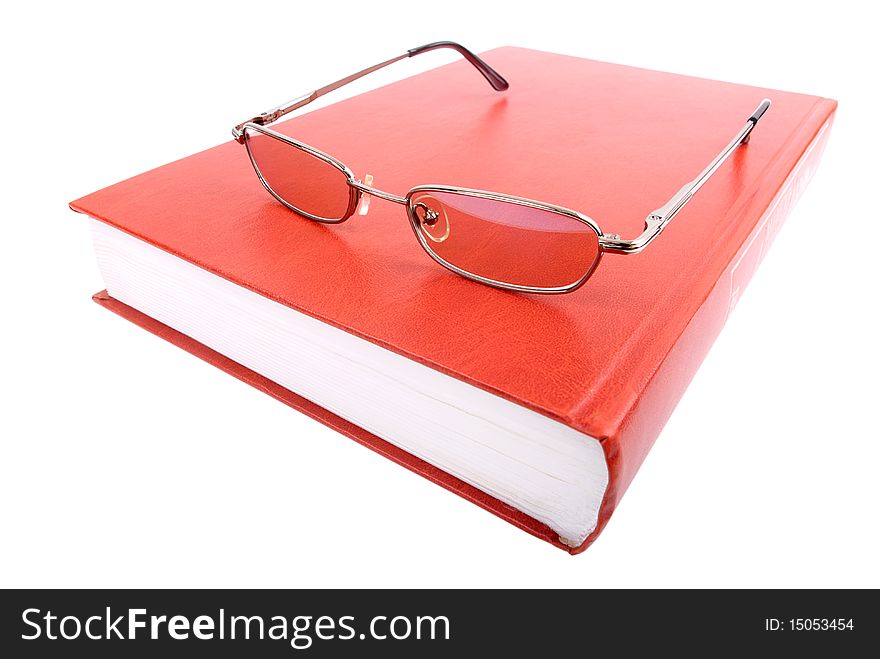 Closed book and glasses on a white background. Closed book and glasses on a white background