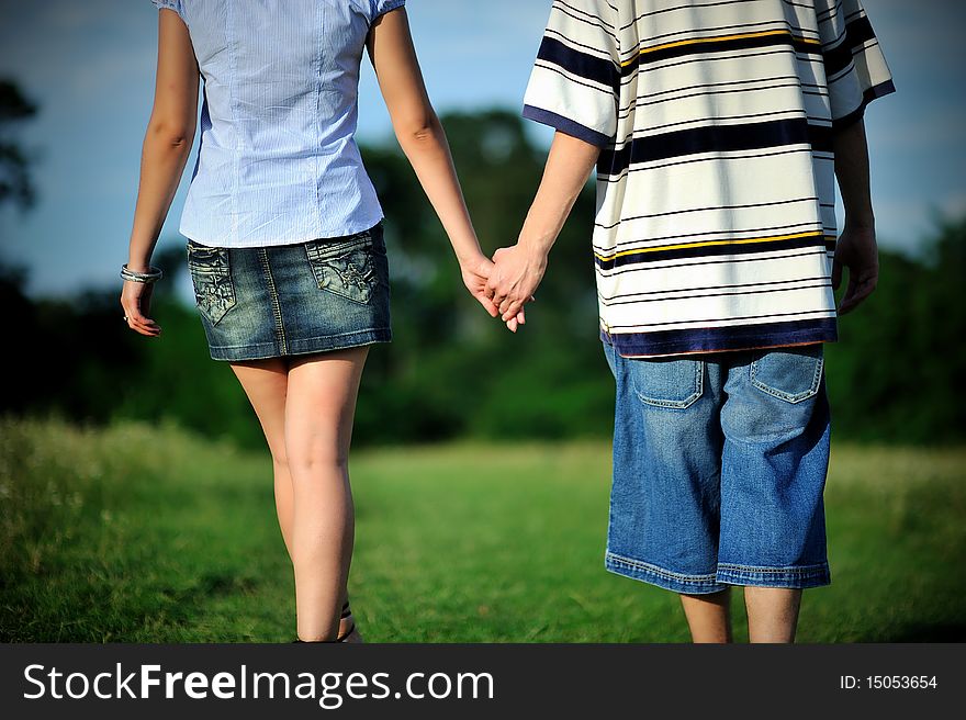 Couple walking outdoor and holding hands. Couple walking outdoor and holding hands