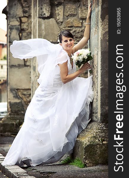 Beautiful bride posing among old church walls